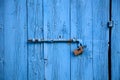 Wooden bright blue, empty, old door for background. Rusty latch, padlock. Close up, banner, details Royalty Free Stock Photo