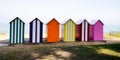 Wooden brightly coloured beach huts on West atlantic beach french in summertime