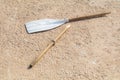 Wooden broken oar, on tan concrete, in the sun. Royalty Free Stock Photo