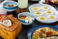 Wooden brown cracked table set with Breakfast of natural healthy food, scrambled eggs, oatmeal, omelette with vegetables, fruit, Royalty Free Stock Photo