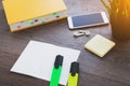 desktop with stationery, smartphone and textbook Royalty Free Stock Photo