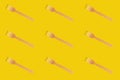 Wooden brown disposable tableware. Fork pattern. On a yellow background