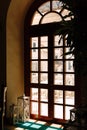 Wooden brown door with glass overlooking the balcony with tables and chairs for relaxation.