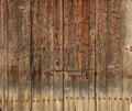 Wooden brown timeworn door. Space for text backdrop, rusty latch and padlock. Closeup view, details.