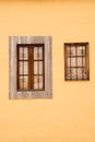 Wooden brown windows. Orange wall. Royalty Free Stock Photo