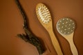 wooden brush for anticellulite massage on a brown table. still life, spa procedures, wellbeing mock up. close up. Royalty Free Stock Photo