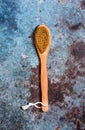 Wooden brush for body and shower massage. Skin care on a blue background