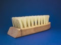 Wooden brush for cleaning shoes on a blue background Royalty Free Stock Photo