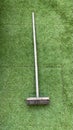 Wooden brush on green grass backdrop Royalty Free Stock Photo