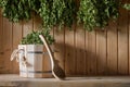 A wooden bucket and a birch broom in a Russian bath. Sauna. Royalty Free Stock Photo