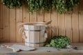 A wooden bucket and a birch broom in a Russian bath. Sauna. Royalty Free Stock Photo