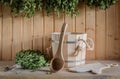 A wooden bucket and a birch broom in a Russian bath. Sauna