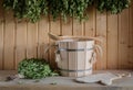 A wooden bucket and a birch broom in a Russian bath. Sauna