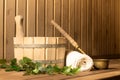 Wooden bucket, birch broom, towel and ladle in the steam room of the sauna Royalty Free Stock Photo