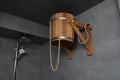 Wooden bucket for russian bathhouse. in the shower Cold water hydrotherapy after sauna. Rustic lifestyle