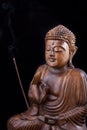 Wooden Buddha on black background