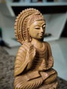 WOODEN BUDDHA STATUE IN LUMINANCE LIGHTING