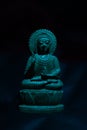 WOODEN BUDDHA STATUE IN LUMINANCE LIGHTING