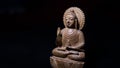 WOODEN BUDDHA STATUE IN LUMINANCE LIGHTING