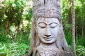 Wooden Buddha statue on green trees background Royalty Free Stock Photo