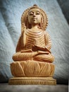 WOODEN BUDDHA STATUE IN LUMINANCE LIGHTING