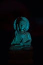 WOODEN BUDDHA STATUE IN LUMINANCE LIGHTING