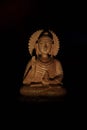 WOODEN BUDDHA STATUE IN LUMINANCE LIGHTING