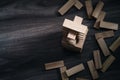 Wooden building blocks tower on wooden background top view with