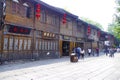 The wooden building beside the street of the scenic spot is used as the facade of the characteristic shops. Plaques, shops,