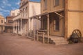 Wooden buildings in a dusty old wild west town street. 3D illustration Royalty Free Stock Photo