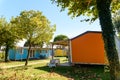 Wooden bungalows inside a summer campsite with brightly painted boards
