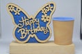 Wooden Butterfly with Happy Birthday Text and Palos Verdes Blue Cup Royalty Free Stock Photo