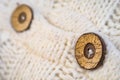 Wooden button on the knitted wool cardigan sweater