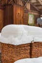 Wooden cabin and firewood covered deeply with snow in little mountain village