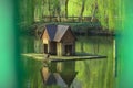 Wooden cabin float on lake water house for birds landscaping object in spring time park outdoor scenic view environment peaceful Royalty Free Stock Photo