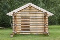 Wooden cabin in the forest under construction. Raw materials Royalty Free Stock Photo