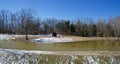 Wooden Cabin on the Snowy Banks of a Pond Royalty Free Stock Photo