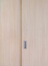 Wooden cabinet slide door with the metal handle in the minimal style Royalty Free Stock Photo