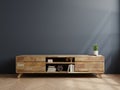 Wooden cabinet for TV in living room on dark blue wall Royalty Free Stock Photo