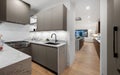 Wooden cabinets and a sleek silver countertop in a modern kitchen Royalty Free Stock Photo