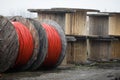 Wooden cable reels outdoors during a cold rainy day