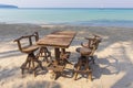 Wooden cafe table and chairs on a tropical beach with blue sea on background, Thailand. Holiday concept Royalty Free Stock Photo
