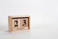 Wooden calendar August 23 on a white background