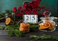 Wooden calendar with date 25 December, Christmas decor, orange chips on wooden background, front view