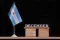 Wooden calendar of December with Argentine flag on black background. Dates of Argentina in December Royalty Free Stock Photo