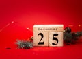 Wooden calendar December 25,on red background. Merry christmas concept Royalty Free Stock Photo