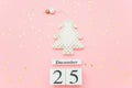 Wooden calendar December 25, textile christmas tree and stars confetti on pink background. Merry christmas concept. Top Royalty Free Stock Photo