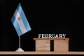 Wooden calendar of February with Argentine flag on black background. Holidays of Argentina in February Royalty Free Stock Photo