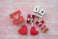 The wooden calendar, 14 February, consists of a box of red hearts written for you and hearts placed side by side with a pink