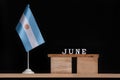 Wooden calendar of June with Argentine flag on black background. Dates of Argentina in June Royalty Free Stock Photo